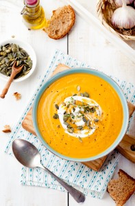 Roasted pumpkin and carrot soup with cream .
